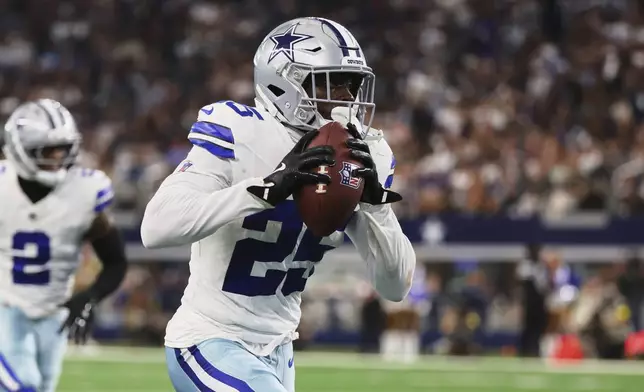 Dallas Cowboys cornerback Andrew Booth intercepts a Baltimore Ravens pass and returns it for a touchdown in the half of a preseason NFL football game Saturday, Aug. 16, 2025, in Arlington, Texas. (AP Photo/Richard Rodriguez)