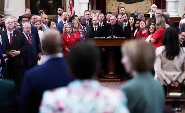 Texas Rep. Todd Hunter, R-Corpus Christi, is surrounded by fellow Republicans as he faces off with Democrats during debate over a redrawn U.S. congressional map in Texas during a special session, Wednesday, Aug. 20, 2025, in Austin, Texas. (AP Photo/Eric Gay)