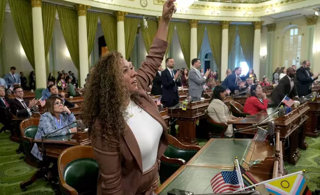California Assembly member Sade Elhawary, D-Los Angeles, celebrates after the Assembly approved the first of three measures to redraw the state's Congressional districts and put new maps before voters in a special election, during a news conference in Sacramento, Calif., Thursday, Aug. 21, 2025. (AP Photo/Rich Pedroncelli)