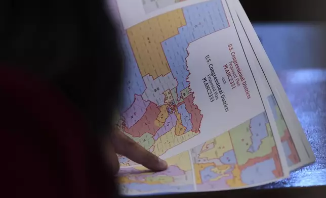 Texas state Rep. Marc LaHood looks over a map as lawmakers prepare to debate a redrawn U.S. congressional map in Texas during a special, Wednesday, Aug. 20, 2025, in Austin, Texas. (AP Photo/Eric Gay)