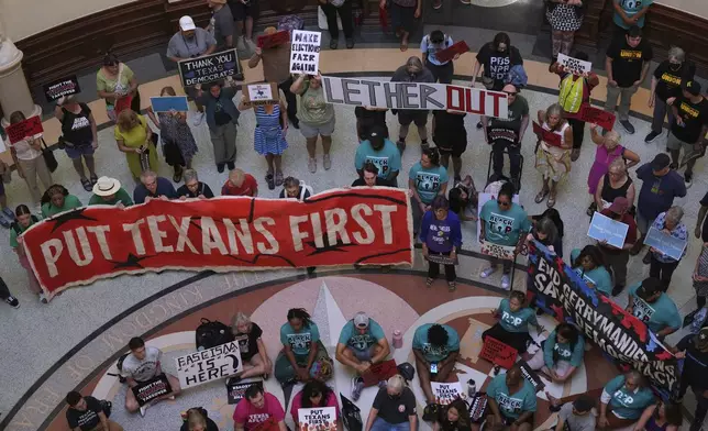 Protesters gather in the rotunda outside the House Chamber at the Texas Capitol as lawmakers debate a redrawn U.S. congressional map in Texas during a special session, Wednesday, Aug. 20, 2025, in Austin, Texas. (AP Photo/Eric Gay)