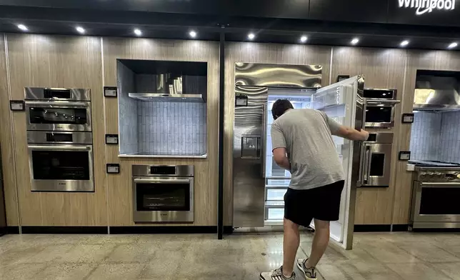 A man views a new appliance at a store in Kennesaw, Ga., on Thursday, Aug. 14, 2025. (AP Photo/Mike Stewart)