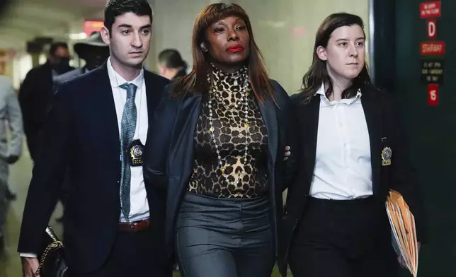 FILE - Ingrid Lewis-Martin is escorted into Manhattan criminal court on Dec. 19, 2024, in New York. (AP Photo/Julia Demaree Nikhinson, File)