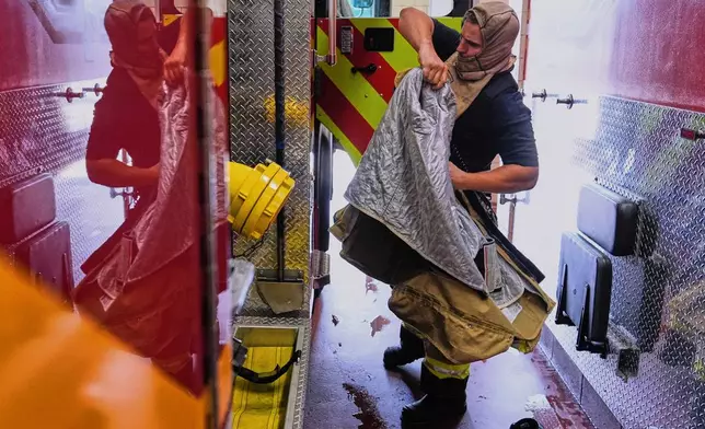 Firefighter Brendan Dyer suits up in recently issued non-PFAS turnout gear at Fire Station 4 in East Providence, R.I., on July 3, 2025. (AP Photo/Charles Krupa)