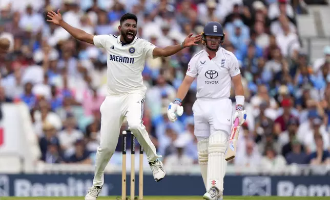 India's Mohammed Siraj, left, appeals successfully for the wicket of England's captain Ollie Pope on day four of the fifth cricket test match between England and India at The Kia Oval in London, Sunday, Aug. 3, 2025. (AP Photo/Kirsty Wigglesworth)