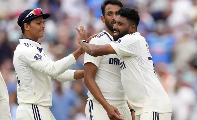 India's Prasidh Krishna, center, celebrates with teammates after the dismissal of England's Joe Root on day four of the fifth cricket test match between England and India at The Kia Oval in London, Sunday, Aug. 3, 2025. (AP Photo/Kirsty Wigglesworth)