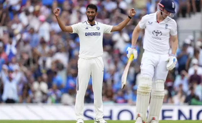 India's Prasidh Krishna, left, celebrates prematurely the wicket of England's Harry Brook, right, on day four of the fifth cricket test match between England and India at The Kia Oval in London, Sunday, Aug. 3, 2025. (AP Photo/Kirsty Wigglesworth)