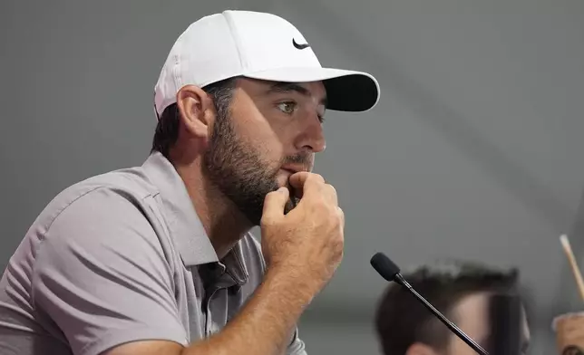 Scottie Scheffler speaks before a practice round of the Tour Championship golf tournament, Wednesday, Aug. 20, 2025, in Atlanta. (AP Photo/Mike Stewart)