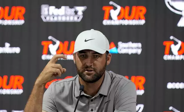 Scottie Scheffler speaks before a practice round of the Tour Championship golf tournament, Wednesday, Aug. 20, 2025, in Atlanta. (AP Photo/Mike Stewart)