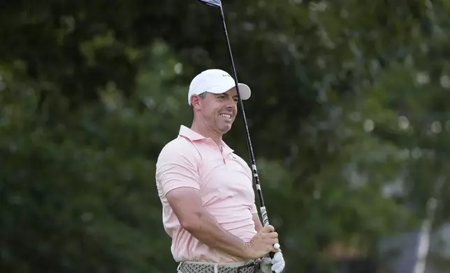 Rory McIlroy, of Northern Ireland, watches his ball from the third tee during a practice round of the Tour Championship golf tournament, Wednesday, Aug. 20, 2025, in Atlanta. (AP Photo/Mike Stewart)