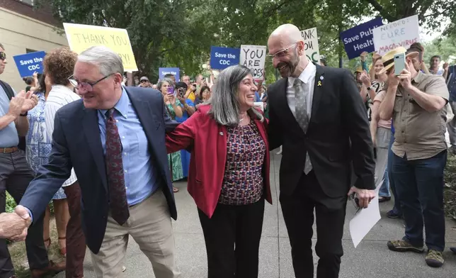 Dr. Daniel Jernigan, leader of the agency's work on emerging infectious diseases; left, Dr. Debra Houry, the agency's deputy director and Dr. Demetre Daskalakis, a top vaccine official, gather as workers and supporters rally for departing scientific leaders at the Centers for Disease Control and Prevention outside the CDC headquarters, Thursday, Aug. 28, 2025, in Atlanta. (AP Photo/Ben Gray)