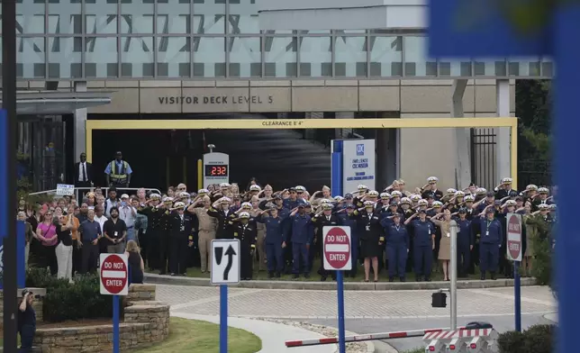 Workers and supporters salute to departing scientific leaders at the Centers for Disease Control and Prevention at the CDC headquarters, Thursday, Aug. 28, 2025, in Atlanta. (AP Photo/Ben Gray)