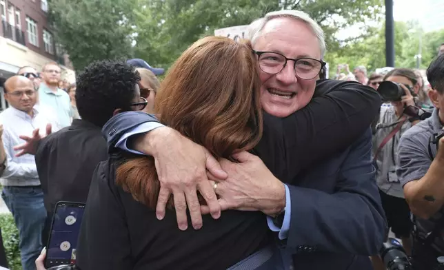 Dr. Daniel Jernigan, leader of the agency's work on emerging infectious diseases hugs his friend as workers and supporters rally for departing scientific leaders at the Centers for Disease Control and Prevention outside the CDC headquarters, Thursday, Aug. 28, 2025, in Atlanta. (AP Photo/Ben Gray)