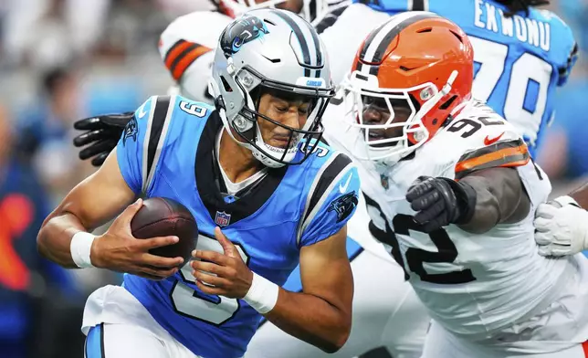 Carolina Panthers quarterback Bryce Young breaks away from Cleveland Browns defensive end Sam Kamara during the first half of a preseason NFL football game on Friday, Aug. 8, 2025, in Charlotte, N.C. (AP Photo/Jacob Kupferman)