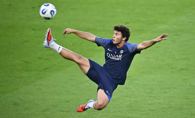 PSG's Joao Neves tries to control a ball during a training session in Udine, Tuesday, Aug. 12, 2025 ahead of Wednesday's UEFA Super Cup soccer match between Paris Saint-Germain and Tottenham Hotspur. (AP Photo/Denes Erdos)
