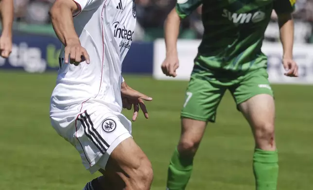 Eintracht Frankfurt's Ritsu Doan scores a goal during the first round of a German Cup soccer game against FV Engers at Oberwerth stadium, Sunday, Aug. 17, 2025, in Koblenz. (Thomas Frey/dpa via AP)