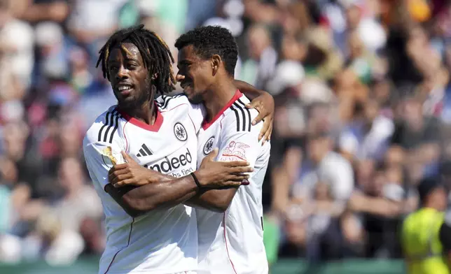 Frankfurt's Elye Wahi, left, and Ansgar Knauff, right, celebrate after the German soccer cup first round match between FV Engers and Eintracht Frankfurt in Koblenz, Germany, Sunday Aug. 17, 2025. (Thomas Frey/dpa via AP)