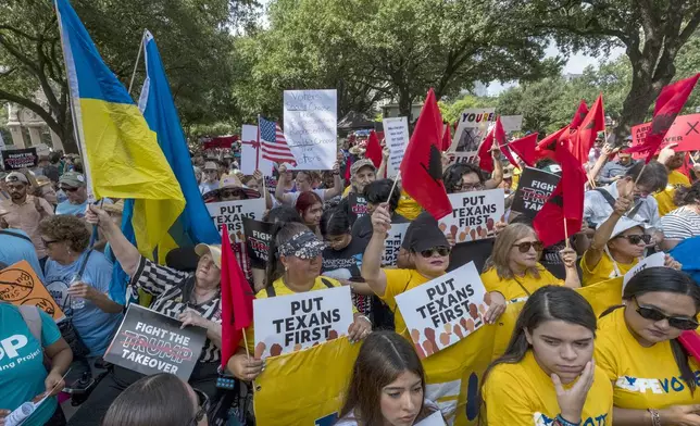 Supporters gather in the shade during the Fight The Trump Takeover Rally held at the State Capitol, Saturday, Aug. 16, 2025, in Austin, Texas, to protest congressional redistricting efforts by Texas Republicans and President Donald Trump. (AP Photo/Rodolfo Gonzalez)
