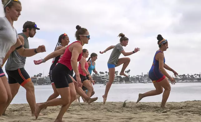 Athletes train at a beach sprints camp organized by USRowing in Long Beach, Calif., Sunday, Aug. 10, 2025. (AP Photo/Damian Dovarganes)