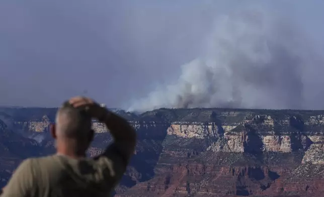 Smoke rises from the Dragon Bravo Fire at the Grand Canyon as seen from Mather Point near Grand Canyon Village, Ariz., Monday, July 28, 2025. (AP Photo/Jon Gambrell)