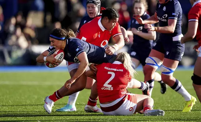 FILE - Scotlands Emma Wassell, left, in action during the Women's Six Nations match at Cardiff Arms Park, Cardiff, Wales, Saturday March 23, 2024. (David Davies/PA via AP,File)