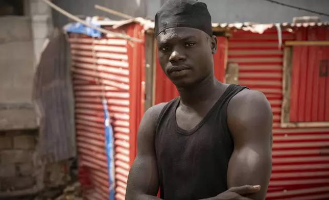 Kawsu Leigh, a fisherman who was injured in a seabound arson attack, stands for a portrait at his home in Banjul, Gambia, on March 25, 2025, almost a year after an attack on the foreign-owned vessel Abu Islam where he was working. (AP Photo/Grace Ekpu)