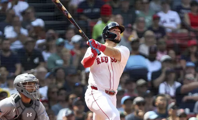 The Boston Red Sox's Wilyer Abreu, right, watches the flight of his fourth-inning two-run home run during a baseball game against the Miami Marlins, Sunday, Aug. 17, 2025, in Boston. (AP Photo/Jim Davis)