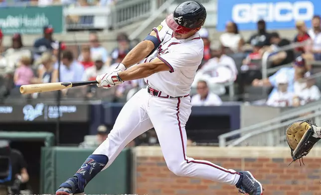 Atlanta Braves' Drake Baldwin hits an RBI single in the third inning of a baseball game against the Miami Marlins, Saturday, Aug. 9, 2025, in Atlanta. (AP Photo/Colin Hubbard)