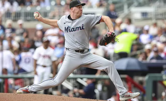 Miami Marlins pitcher Ryan Gusto delivers in the third inning of a baseball game against the Atlanta Braves, Saturday, Aug. 9, 2025, in Atlanta. (AP Photo/Colin Hubbard)