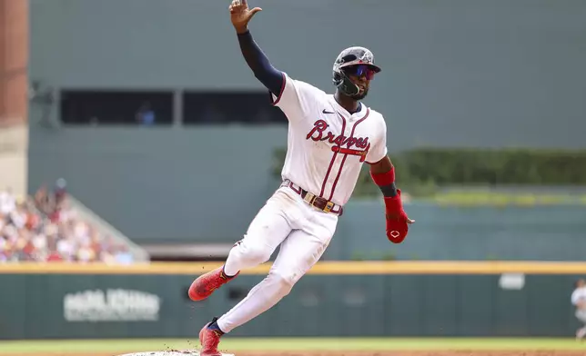 Atlanta Braves' Jurickson Profar rounds third base in the third inning of a baseball game against the Miami Marlins, Saturday, Aug. 9, 2025, in Atlanta. (AP Photo/Colin Hubbard)