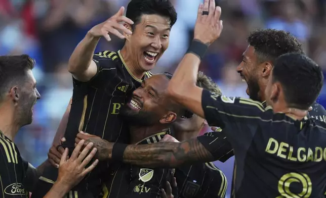 Los Angeles FC forward Heung Min Son, top, celebrates with teammates after scoring during the first half of an MLS soccer match against FC Dallas in Frisco, Texas, Saturday, Aug. 23, 2025. (AP Photo/LM Otero)