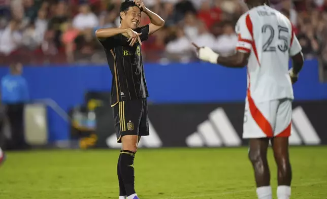 Los Angeles FC forward Heung Min Son, left, looks to FC Dallas defender Sebastien Ibeagha (25) during the second half of an MLS soccer match in Frisco, Texas, Saturday, Aug. 23, 2025. (AP Photo/LM Otero)