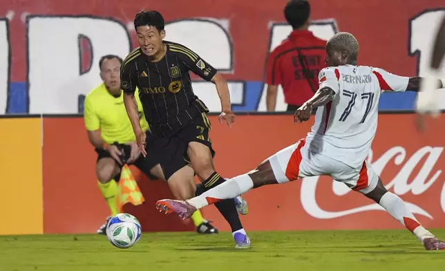 Los Angeles FC forward Heung Min Son, front left, gets past FC Dallas forward Bernard Kamungo (77) during the first half of an MLS soccer match in Frisco, Texas, Saturday, Aug. 23, 2025. (AP Photo/LM Otero)