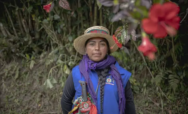 Patricia Elago Zetty, an Indigenous Guard, poses for a photo on July 16, 2025, in Caldono, Colombia. (AP Photo/Nadège Mazars)