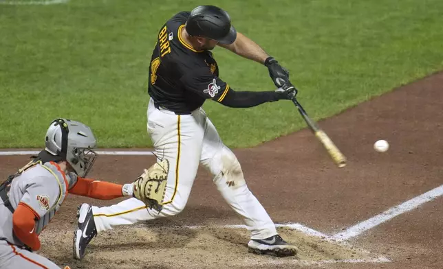 Pittsburgh Pirates' Joey Bart, right, hits a single off San Francisco Giants pitcher Randy Rodríguez, driving in a run, during the ninth inning of a baseball game in Pittsburgh, Monday, Aug. 4, 2025. (AP Photo/Gene J. Puskar)