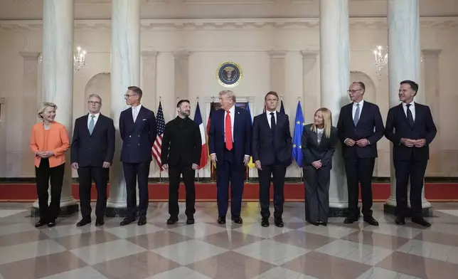 European Commission President Ursula von der Leyen, from left, British Prime Minister Keir Starmer, Finland's President Alexander Stubb, Ukrainian President Volodymyr Zelenskyy, President Donald Trump, France's President Emmanuel Macron, Italy's Prime Minister Giorgia Meloni, Germany's Chancellor Friedrich Merz and NATO Secretary General Mark Rutte stand before a group photo in the Grand Foyer of the White House, Monday, Aug. 18, 2025, in Washington. (AP Photo/Alex Brandon)