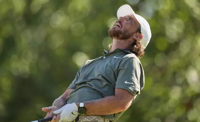 Tommy Fleetwood, of England, reacts to his tee shot on the 18th hole during the third round of the St. Jude Championship golf tournament Saturday, Aug. 9, 2025, in Memphis, Tenn. (AP Photo/George Walker IV)