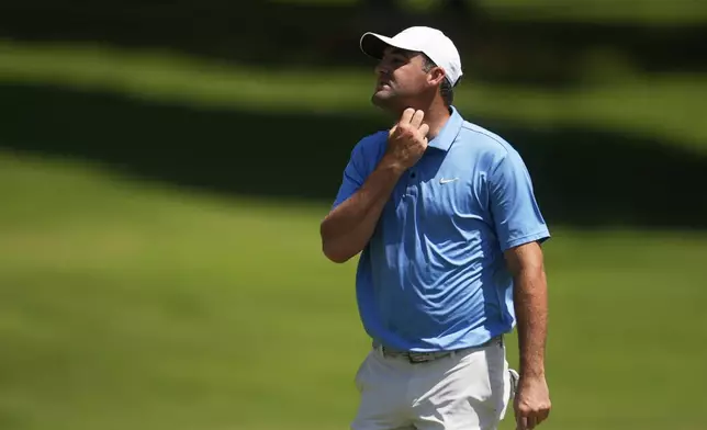 Scottie Scheffler walks off the first green during the third round of the St. Jude Championship golf tournament Saturday, Aug. 9, 2025, in Memphis, Tenn. (AP Photo/George Walker IV)