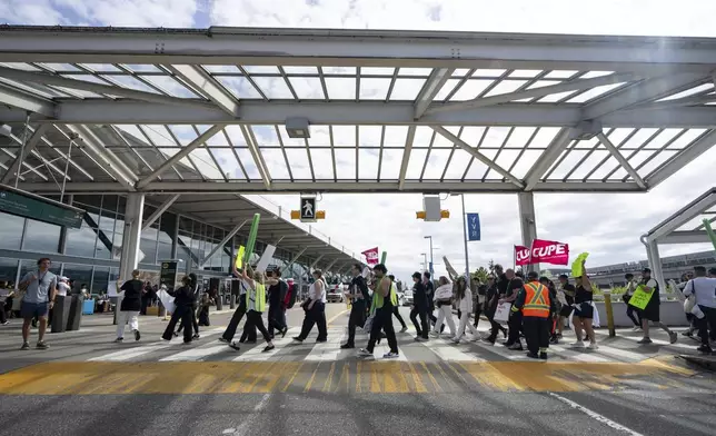 Picketers march around the departures level at the Vancouver International Airport in Richmond, British Columbia, Sunday, Aug. 17, 2025. (Ethan Cairns/The Canadian Press via AP)