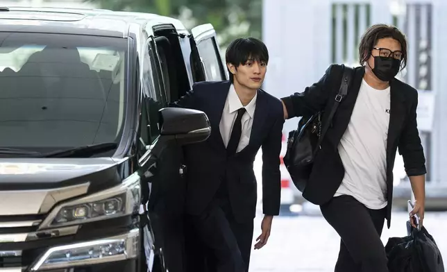 J-pop star Kenshin Kamimura arrives at the West Kowloon Magistrates' Courts to hear verdict over his indecent assault case in Hong Kong, Wednesday, August 13, 2025. (AP Photo/Chan Long Hei)