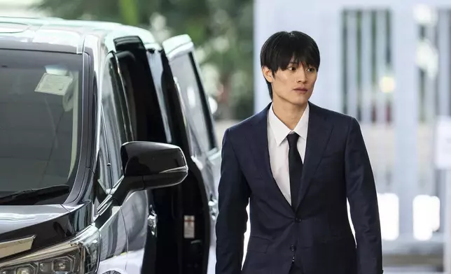 J-pop star Kenshin Kamimura arrives at the West Kowloon Magistrates' Courts to hear verdict over his indecent assault case in Hong Kong, Wednesday, August 13, 2025. (AP Photo/Chan Long Hei)