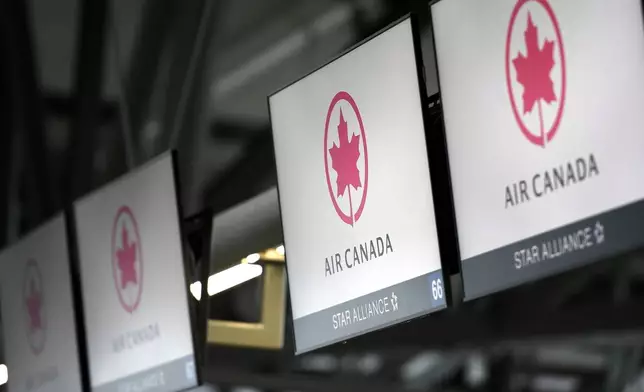 FILE - This May 16, 2020 file photo shows Air Canada check screens at Ottawa International Airport in Ottawa, Ontario, Canada. (Justin Tang/The Canadian Press via AP, File)