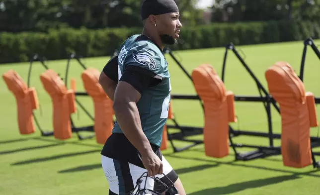 Philadelphia Eagles running back Saquon Barkley runs on to the field during practice at the team’s NFL football training camp, Thursday, July 24, 2025, in Philadelphia. (AP Photo/Matt Rourke)