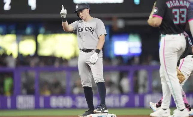 New York Yankees' Ben Rice, left, celebrates after hitting a double in the fifth inning of a baseball game against the Miami Marlins, Saturday, Aug. 2, 2025, in Miami. (AP Photo/Jim Rassol)