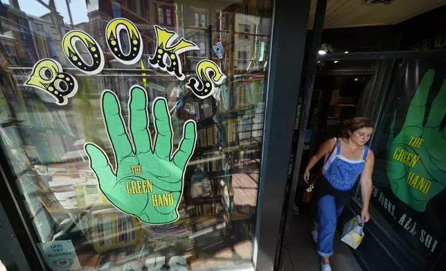 A customer leaves the Green Hand Bookstore in Portland, Maine, on Thursday, Aug. 7, 2025. (AP Photo/Robert F. Bukaty)