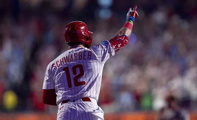 Philadelphia Phillies' Kyle Schwarber reacts to hitting a grand slam home run during the sixth inning of a baseball game against the Baltimore Orioles, Monday, Aug. 4, 2025, in Philadelphia. (AP Photo/Chris Szagola)