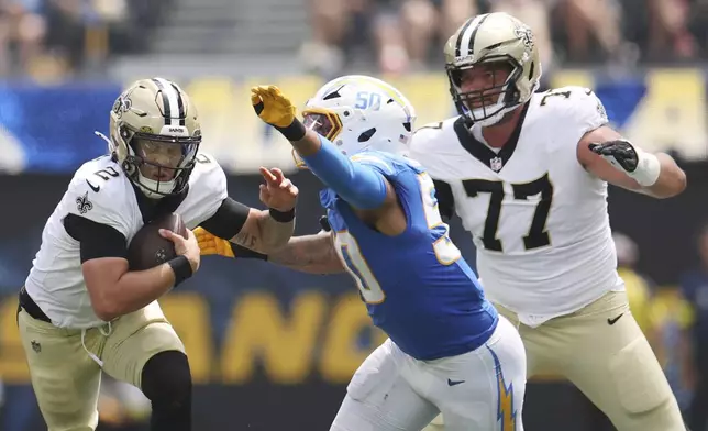 New Orleans Saints quarterback Spencer Rattler (2) is tackled by Los Angeles Chargers linebacker Caleb Murphy (50) during the first half of a preseason NFL football game Sunday, Aug. 10, 2025, in Inglewood, Calif. (AP Photo/Eric Thayer)