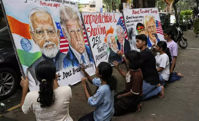 Students of Gurukul school of Art work on paintings of U.S. President Donald Trump and Prime Minister of India Narendra Modi, in Mumbai, India, Friday, Aug. 1, 2025. (AP Photo/Rajanish Kakade)