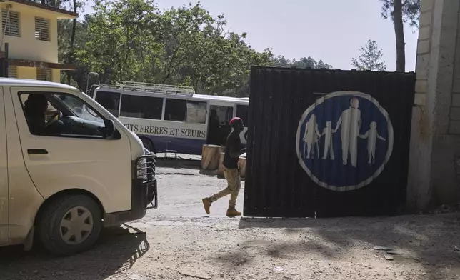 Workers enter the Saint-Helene orphanage in the Kenscoff neighborhood of Port-au-Prince, Haiti, Monday, Aug. 4, 2025. (AP Photo/Odelyn Joseph)