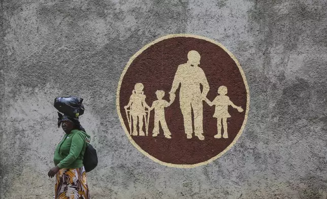 A woman walks past the Saint-Helene orphanage in the Kenscoff neighborhood of Port-au-Prince, Haiti, Monday, Aug. 4, 2025. (AP Photo/Odelyn Joseph)